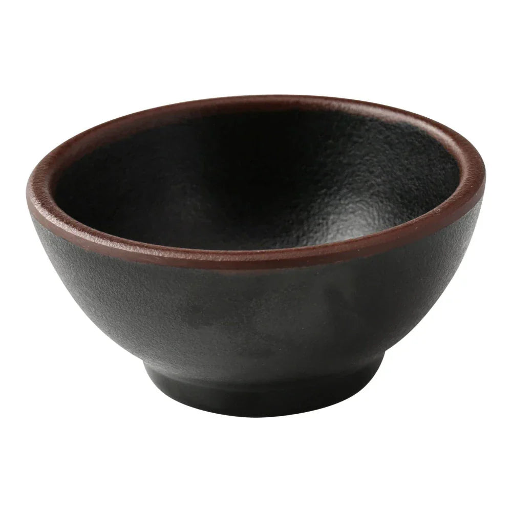 Yanco Sauce Dish NA-5003BK Made from high-quality melamine, this server is both durable and lightweight. Its round shape and break-resistant nature make it suitable for frequent use in commercial dining environments. This server is designed to be dishwasher safe, ensuring convenient and efficient cleaning, essential for high-turnover settings. The black color with a speckled finish and brown rim adds a sophisticated touch to the presentation of sauces and condiments.