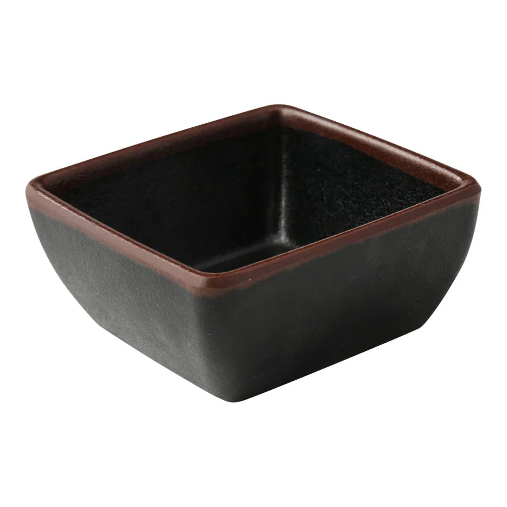 Yanco Square Sauce Dish NA-5004BK Made from high-quality melamine, this server is durable and lightweight. Its square shape and break-resistant nature make it ideal for frequent use in commercial dining settings. This server is designed to be dishwasher safe, ensuring easy and efficient cleaning, which is essential for high-turnover environments. The black color with a speckled finish and brown rim adds a touch of elegance to the presentation of sauces and condiments.