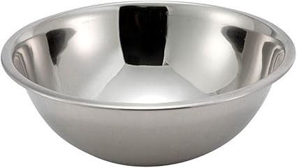 3/4 qt. stainless steel mixing bowl stanton trading, with a 6-1/4" diameter and a polished, reflective surface. It has a smooth, rounded interior and a slightly flared rim for easy handling. The sturdy construction makes it ideal for mixing, baking, and food prep. Its simple design suits both home and professional kitchens.