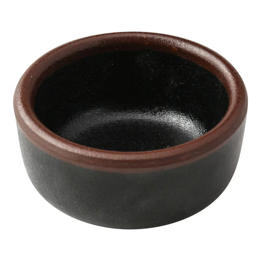 Yanco Sauce Dish NA-5002BK Made from high-quality melamine, this server is both durable and lightweight. Its round shape and break-resistant nature make it suitable for frequent use in commercial dining environments. This server is designed to be dishwasher safe, ensuring convenient and efficient cleaning, essential for high-turnover settings. The black color with a speckled finish and brown rim adds a sophisticated touch to the presentation of sauces and condiments.