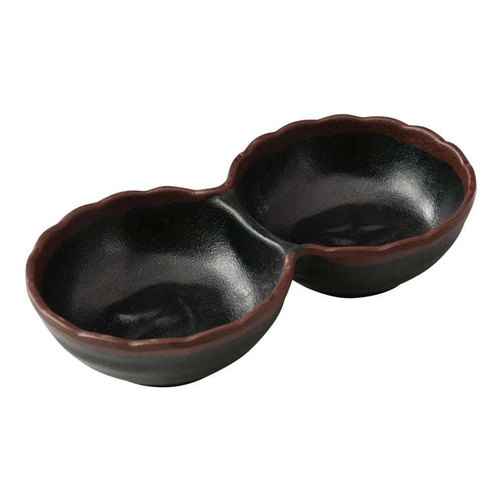 Yanco Two-Divided Sauce Dish NA-506BK Made from durable melamine, it is designed for break resistance and easy handling. This server features two compartments, each with a capacity of 2 ounces, suitable for serving various condiments or sauces. The design includes an black color with a speckled brown rim, adding an attractive touch to the table. It is dishwasher safe, which ensures convenient and thorough cleaning, though it is not microwave safe. 