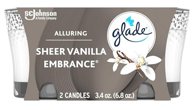 Two Glade Sheer Vanilla Embrace scented candles in glass jars, 3.4 oz each, with a soft, comforting vanilla fragrance.