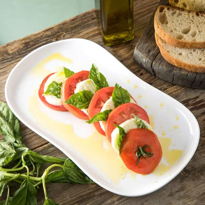 13 x 7 Inch White Stadia Melamine Platter with commercial grade break resistant construction and a modern organic shape. Perfect for serving appetizers, seafood, sandwiches, entrees, desserts and shared dishes.