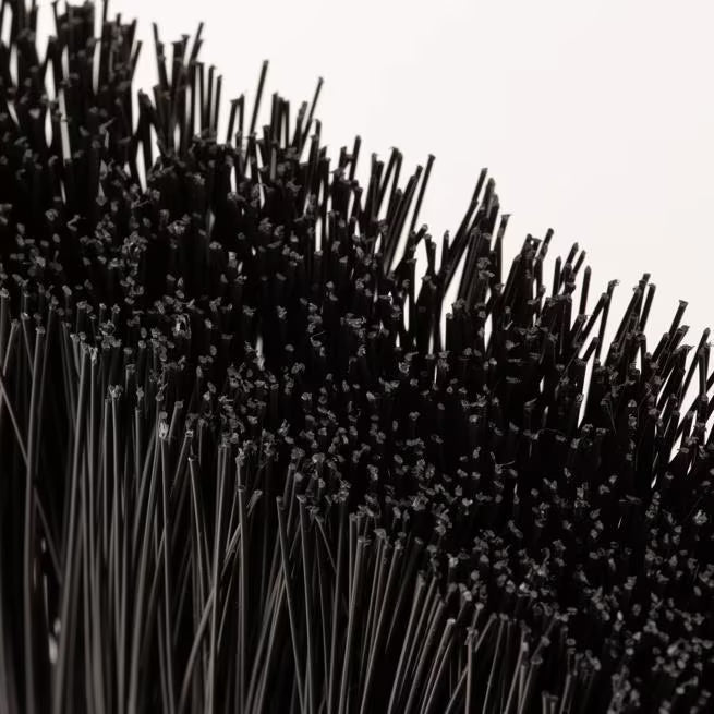 11 Inch Black Duo-Sweep Unflagged Broom with a 48 Inch blue metal handle, stiff synthetic bristles and dual handle positions. Built for heavy duty commercial sweeping and designed to outlast traditional corn brooms.