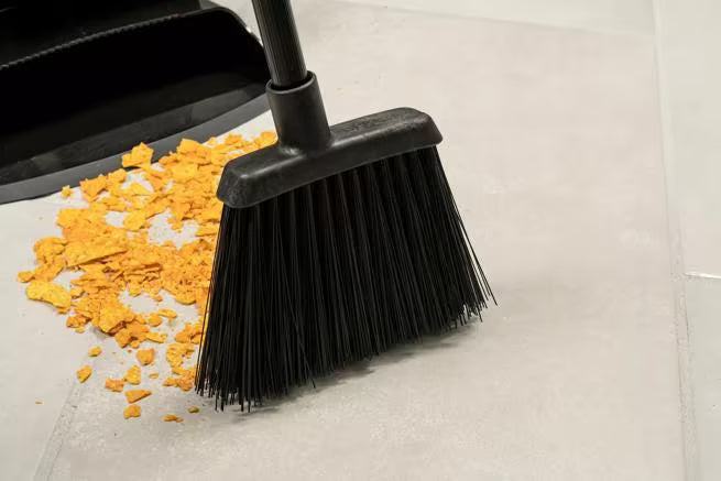 30 Inch Black Duo-Sweep Unflagged Lobby Broom with a black metal handle, stiff synthetic bristles and an angled brush head. Built for heavy duty commercial sweeping and designed to outlast traditional corn brooms.