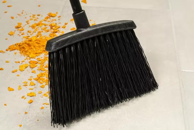 48 Inch Black Duo-Sweep Unflagged Warehouse Broom with a black metal handle, angled brush head and stiff synthetic bristles. Built for heavy duty commercial sweeping and designed to outlast traditional corn brooms.