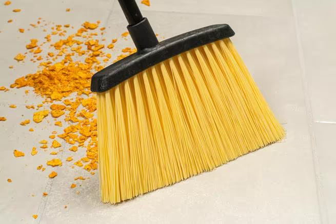 48 Inch Natural Duo-Sweep Unflagged Heavy Duty Angle Broom with a black metal handle and a 12 Inch angled brush head. Designed for heavy duty commercial sweeping in warehouses and other demanding environments.