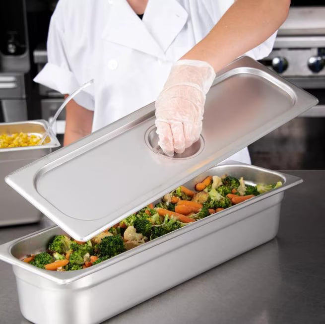 Protect food with the DuraPan Light Gauge Stainless Steel Steam Table Long Hotel Pan Cover Half-Size 60700HLC. Features durable stainless steel construction and a comfortable concave handle.
