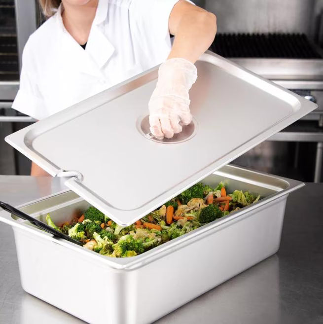 Protect and serve food efficiently with the DuraPan Stainless Steel Hotel Pan Slotted Handled Cover Full-Size 607000CS. Features heavy gauge stainless steel, a serving spoon notch, and a comfortable concave handle.