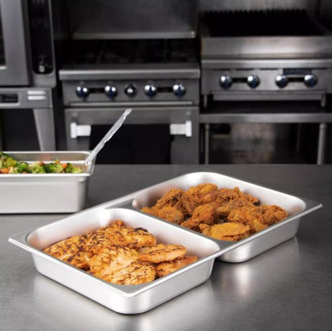 Serve two food items efficiently with the DuraPan Stainless Steel Divided Steam Table Hotel Pan Full-Size 2.5 Inch Deep 607002D. Features divided sections, spoonable bottoms, freezer-to-oven versatility, and Coldmaster compatibility.