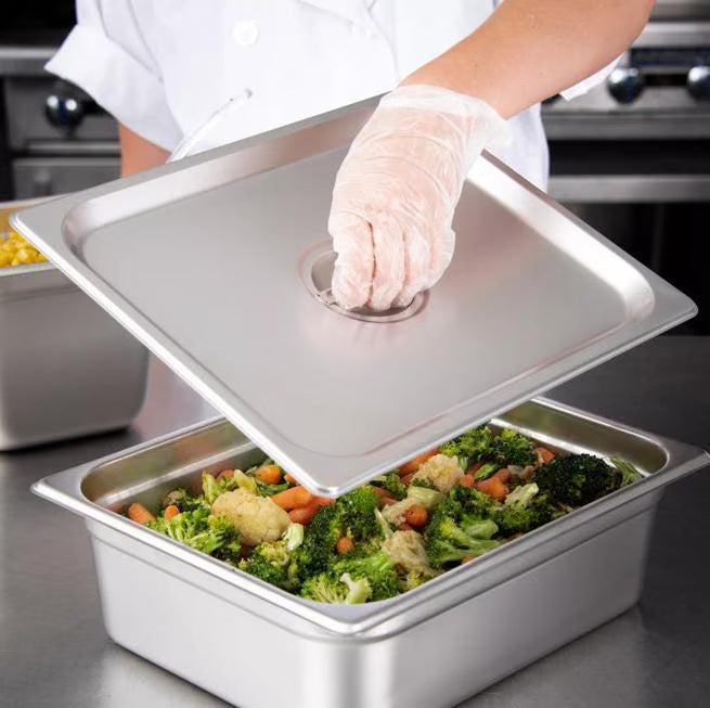 Protect food with the DuraPan Stainless Steel Steam Table Hotel Pan Handled Cover 1/2 Size 607120C. Features heavy gauge stainless steel construction and a comfortable concave handle.