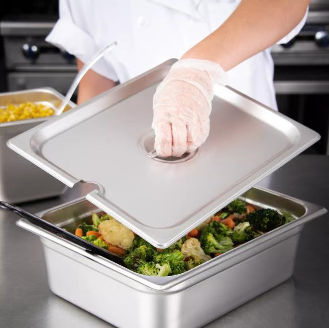 Protect and serve food efficiently with the DuraPan Stainless Steel Hotel Pan Slotted Handled Cover 1/2 Size 607120CS. Features heavy gauge stainless steel, a serving spoon notch, and a comfortable concave handle.