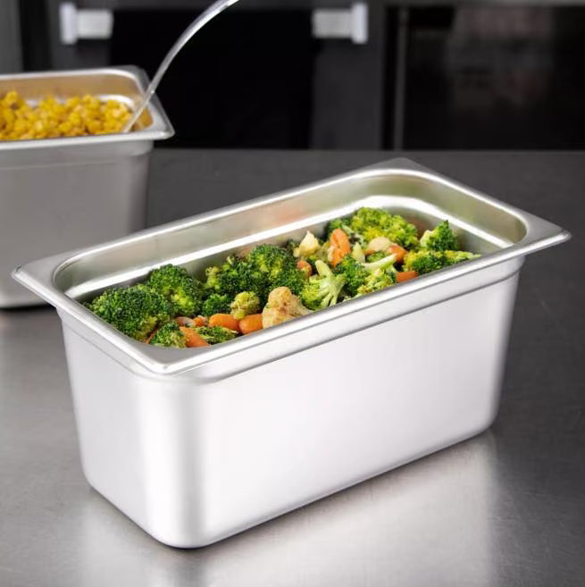 Prepare and serve food efficiently with the DuraPan Light Gauge Stainless Steel Steam Table Hotel Pan 1/3 Size 6 Inch Deep 607136. Features spoonable bottoms, freezer-to-oven versatility, and Coldmaster compatibility.
