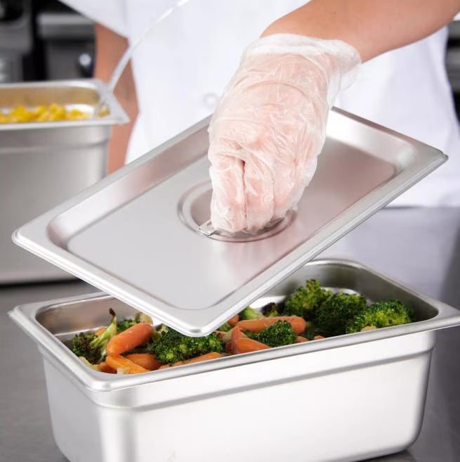 Protect food with the DuraPan Stainless Steel Steam Table Hotel Pan Handled Cover 1/4 Size 607140C. Features heavy gauge stainless steel construction and a comfortable concave handle.