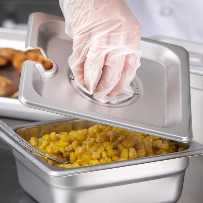 Protect and serve food efficiently with the DuraPan Stainless Steel Hotel Pan Slotted Handled Cover 1/6 Size 607160CS. Features heavy gauge stainless steel, a serving spoon notch, and a comfortable concave handle.