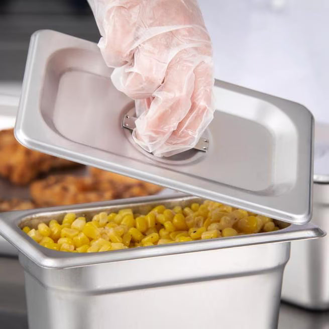 Protect food with the DuraPan Stainless Steel Steam Table Hotel Pan Handled Cover 1/9 Size 607190C. Features heavy gauge stainless steel construction and a comfortable concave handle.