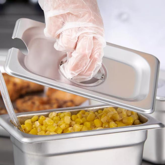 Protect and serve food efficiently with the DuraPan Stainless Steel Hotel Pan Slotted Handled Cover 1/9 Size 607190CS. Features heavy gauge stainless steel, a serving spoon notch, and a comfortable concave handle.