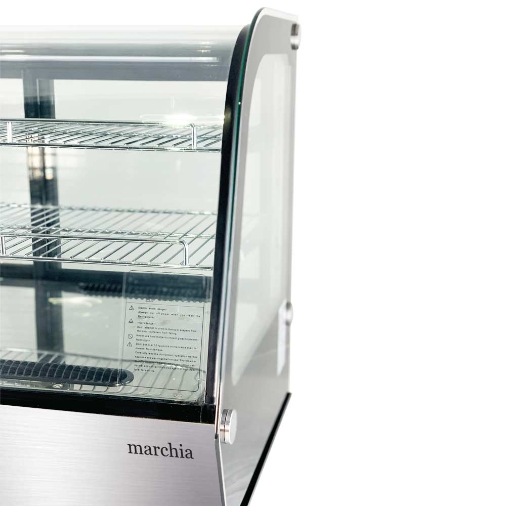Marchia MDC121 28" Countertop Refrigerated Bakery Display Case with curved glass and LED lighting. Features a compact design for elegantly showcasing and keeping baked goods cool and illuminated.