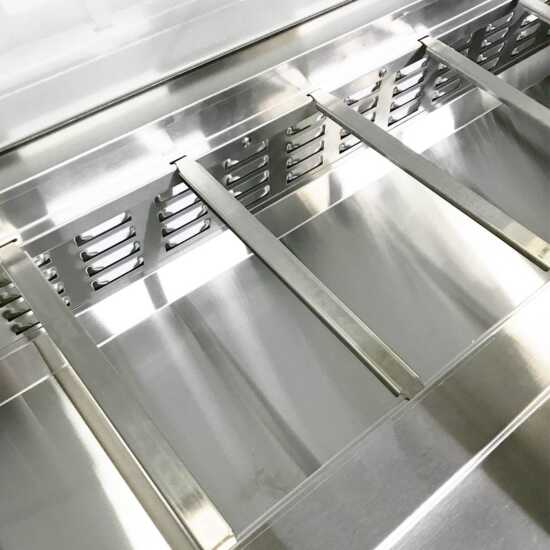 Coldline SP60 60-inch refrigerated sandwich prep table with a cutting board and food pans. This large unit provides extensive prep space, featuring a durable cutting board and multiple food pans for efficient sandwich making.