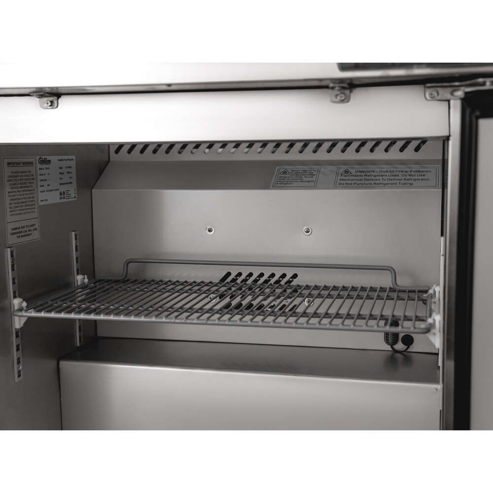 Coldline SPN-29 29" Narrow Depth Refrigerated Sandwich Prep Table with a space-saving design, durable stainless steel construction, cutting board, food pans, and energy-efficient cooling. Perfect for compact commercial kitchens needing efficient food prep and storage.