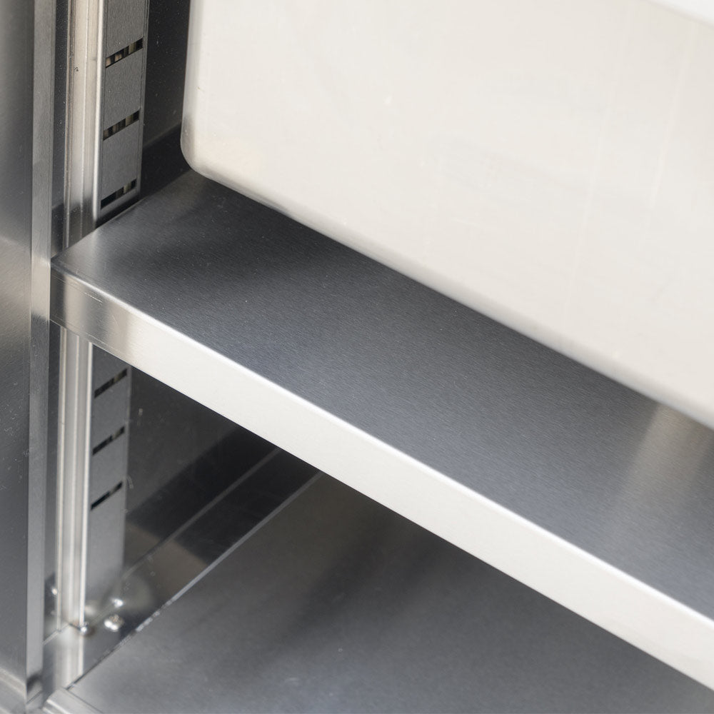 "Stainless steel work table with sink, 24"D x 72"L, featuring an enclosed base and sliding doors, ideal for food prep, cleaning, and efficient workspace organization in commercial kitchens."